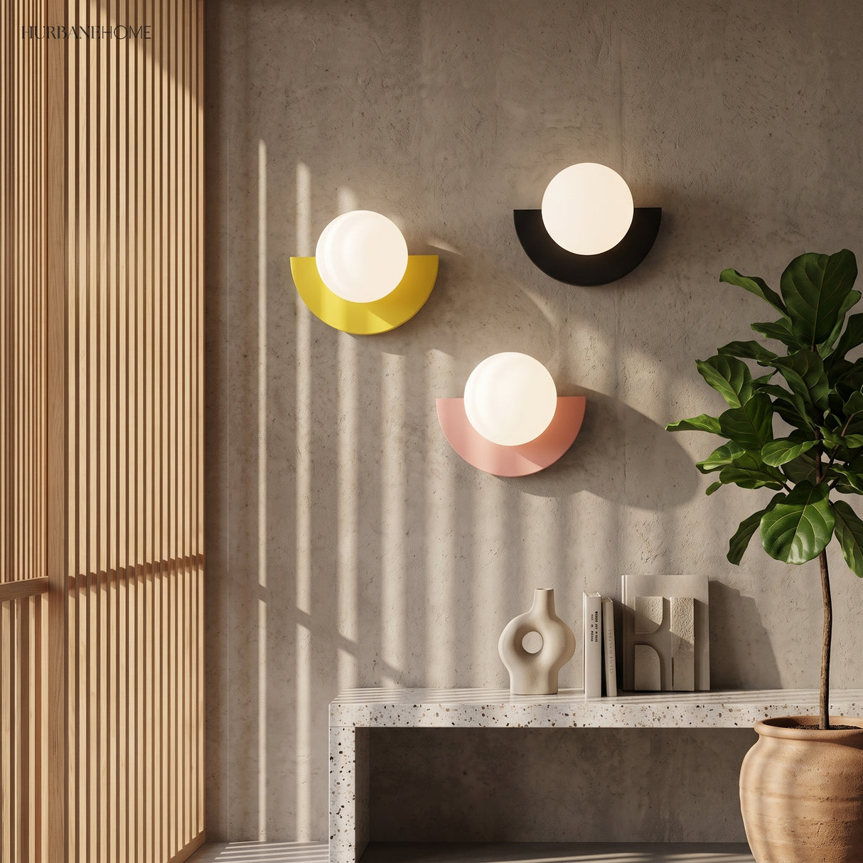 Yellow, black and pink wall sconces grouped on a concrete wall