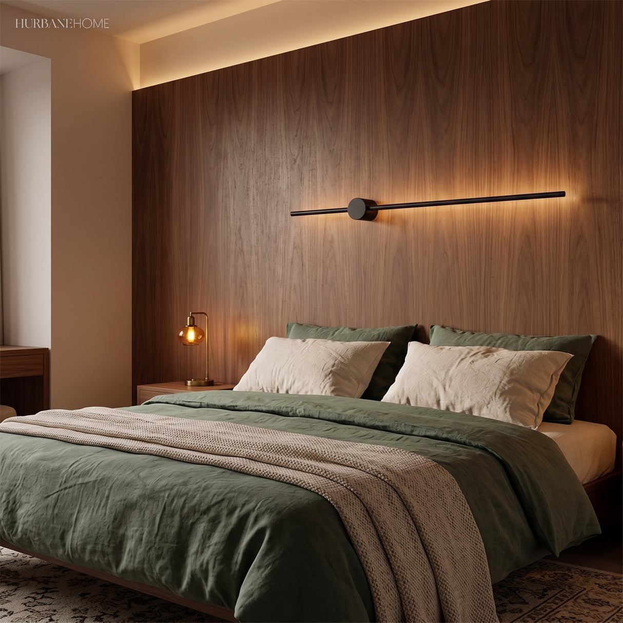 Horizontal black wall light on a walnut panel above a green bed