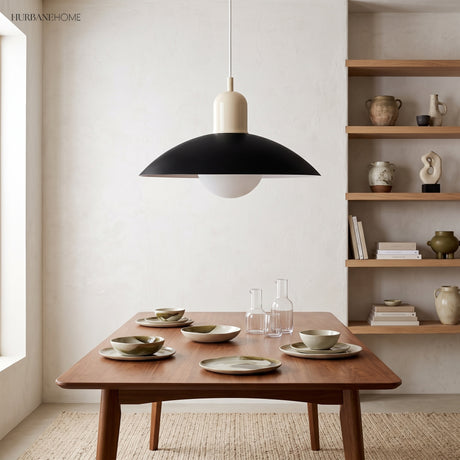 Modern disc pendant light hanging in a bright minimalist living corner