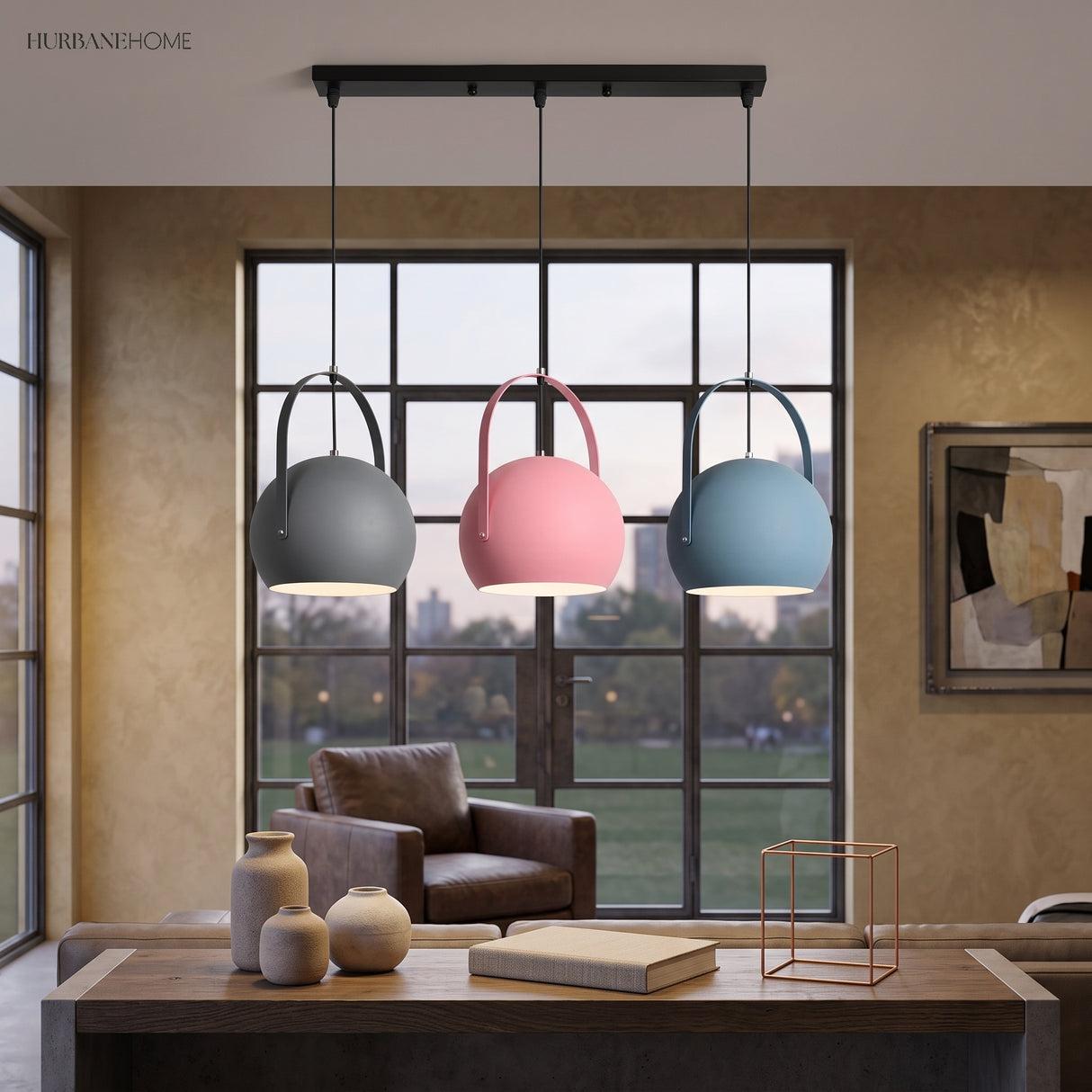 Grey, pink, and blue ball pendant lights in a row by a window