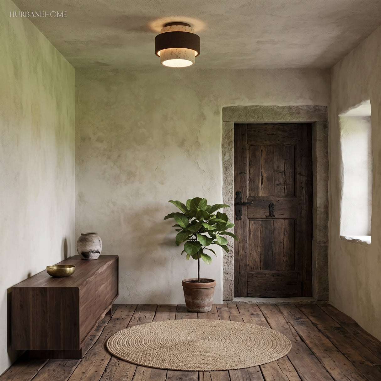 Travertine flush mount ceiling light in a green-walled rustic hallway with timber cabinet