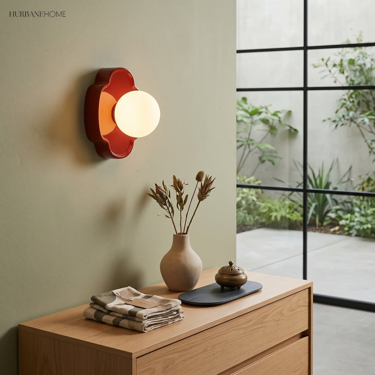 Green flower wall light glowing softly against dark timber slat panelling