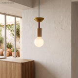 Geometric wood pendant light casting a warm glow in a styled contemporary interior