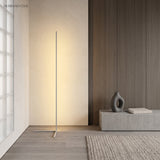 White corner floor lamp casting soft ambient light against a wood panelled wall