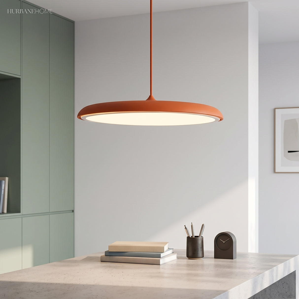 Orange disc pendant light close up showing slim metal shade and frosted diffuser