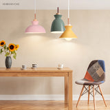 Cluster of Scandinavian pendant lights lighting a cosy dining and living space