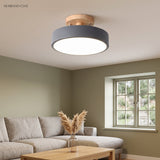 Green macaron ceiling light on a wood mount in a soft modern interior