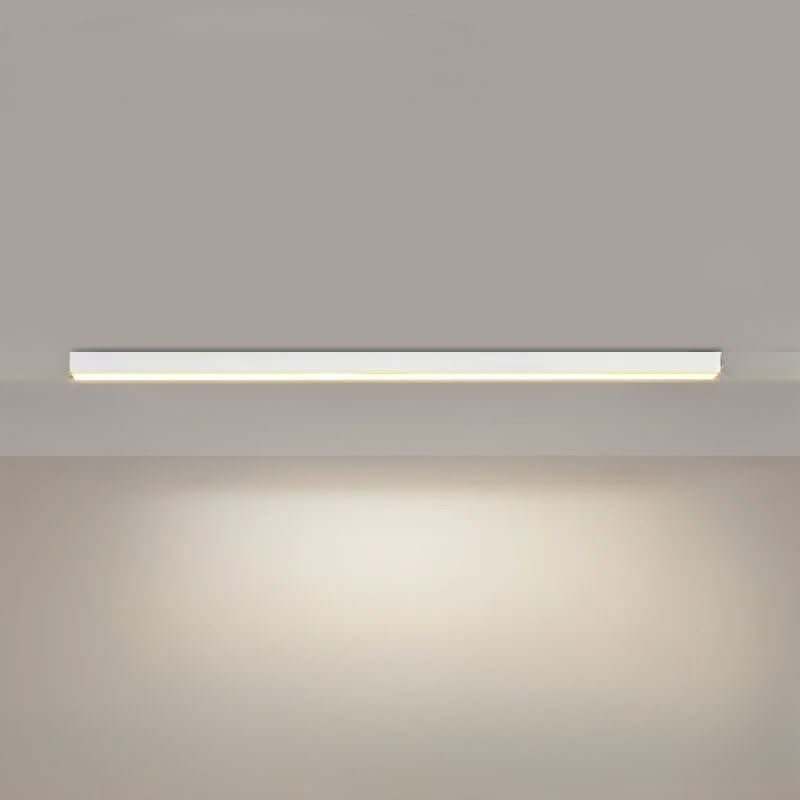 Linear LED ceiling light casting soft light in a minimalist workspace