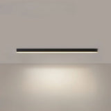 Black linear LED bar light on a ceiling above a minimalist room