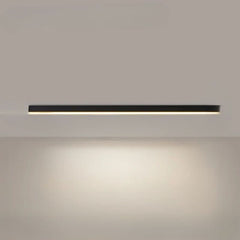 Linear LED ceiling light lit and mounted in a bright modern space
