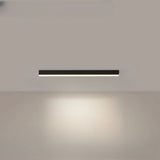 Black linear LED ceiling bar photographed against a pale ceiling