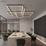 Rectangular frame of linear LED light over a light wood conference table
