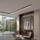 Black linear LED ceiling light in an L-shape above a courtyard lounge area