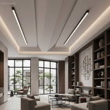 Slim black LED ceiling bars on a slanted ceiling in a neutral living room