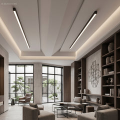 Slim black LED ceiling bars on a slanted ceiling in a neutral living room