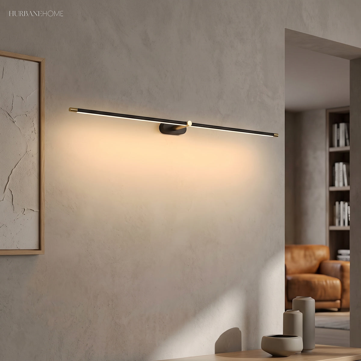 Black linear LED wall light casting a wide glow across a plaster wall