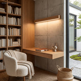 Wood wall light lit above a framed mirror in a panelled timber bathroom