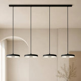 Close view of a flat black disc pendant with a soft central LED glow