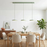 White disc pendants lighting a bright open plan kitchen and dining space