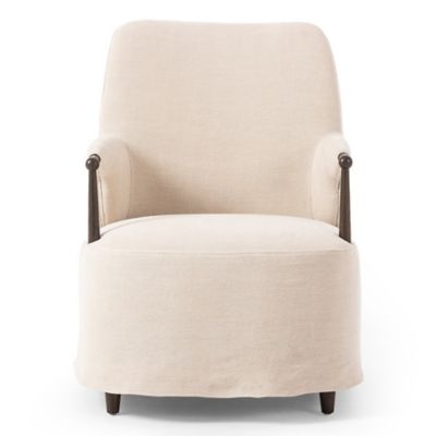 Upholstered chaise lounge chair in linen fabric with tailored skirt