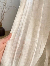 Linen look semi sheer curtains styled in bright balcony space
