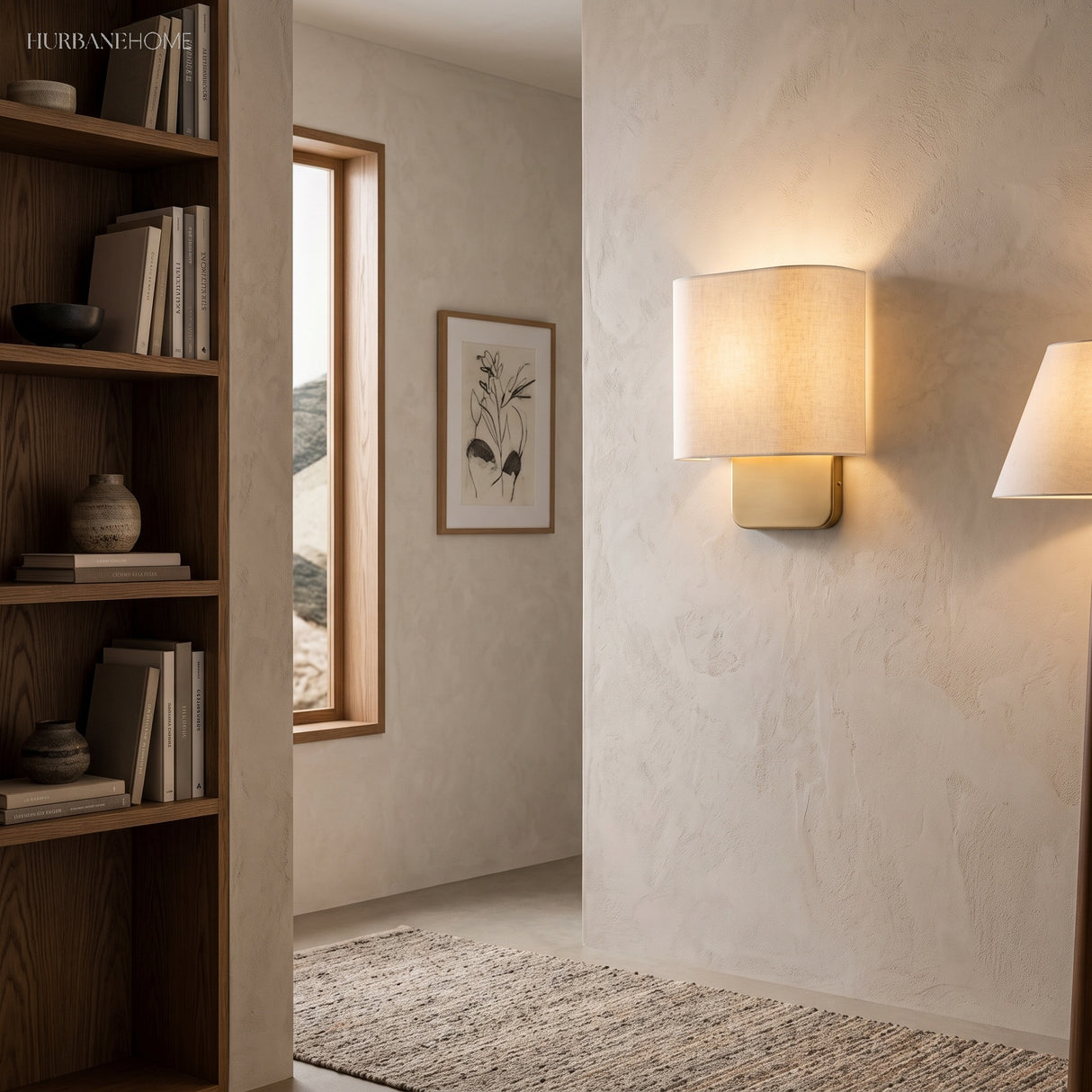 Rectangular linen wall sconce in a plaster hallway beside shelving