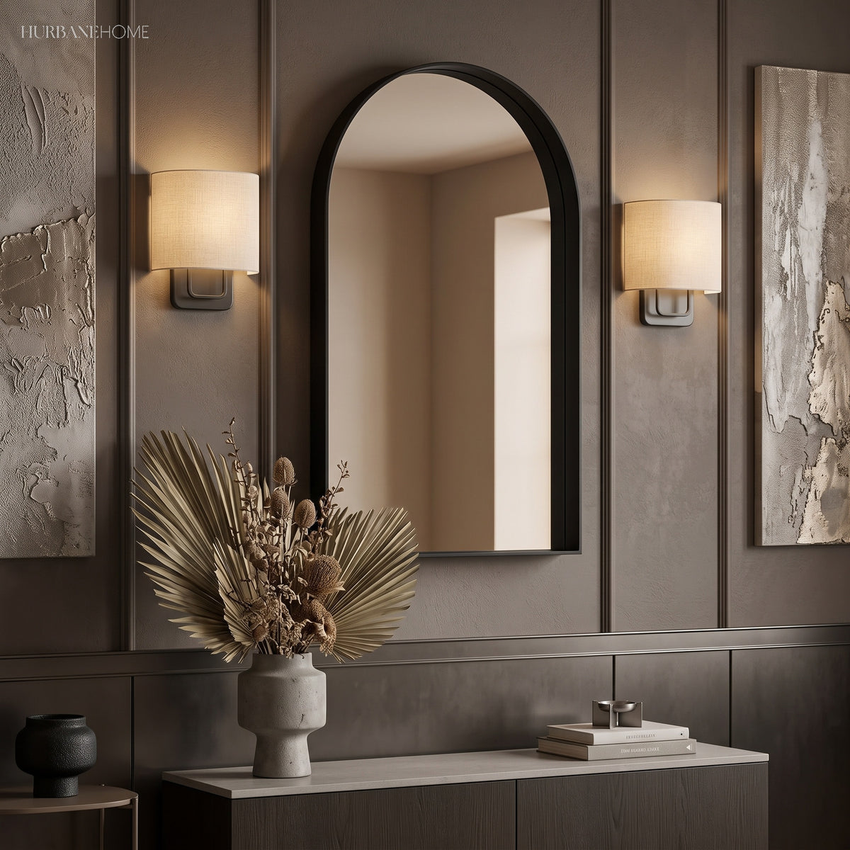 Two linen shade sconces flanking an arched mirror above a sideboard