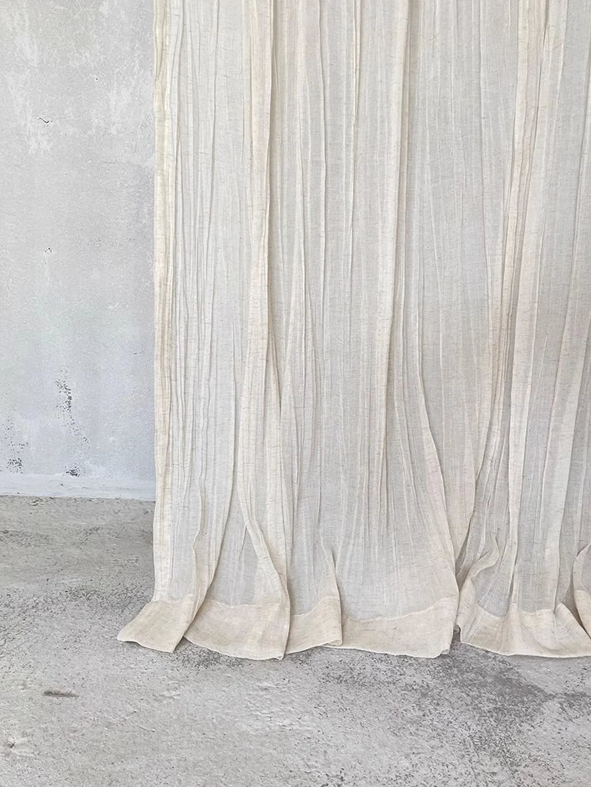 Tie top sheer curtains draped softly across modern living room