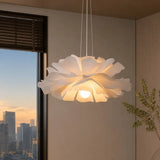 White lotus flower pendant light lit in a corner at dusk