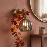 Brass wall sconce with smoke grey scalloped lotus glass shade