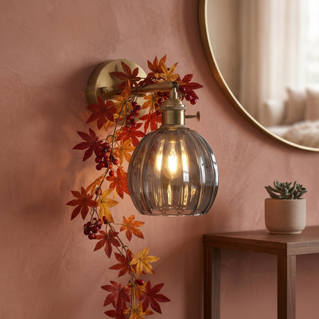 Brass wall sconce with smoke grey scalloped lotus glass shade
