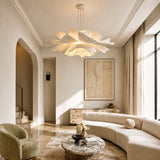 White lotus pendant light glowing over a curved lounge sofa