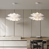 Two white petal pendant lights paired over a kitchen dining area