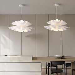Two white petal pendant lights paired over a kitchen dining area