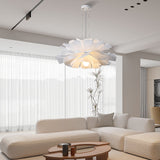 White flower pendant light in a lounge with sheer curtains and a sofa