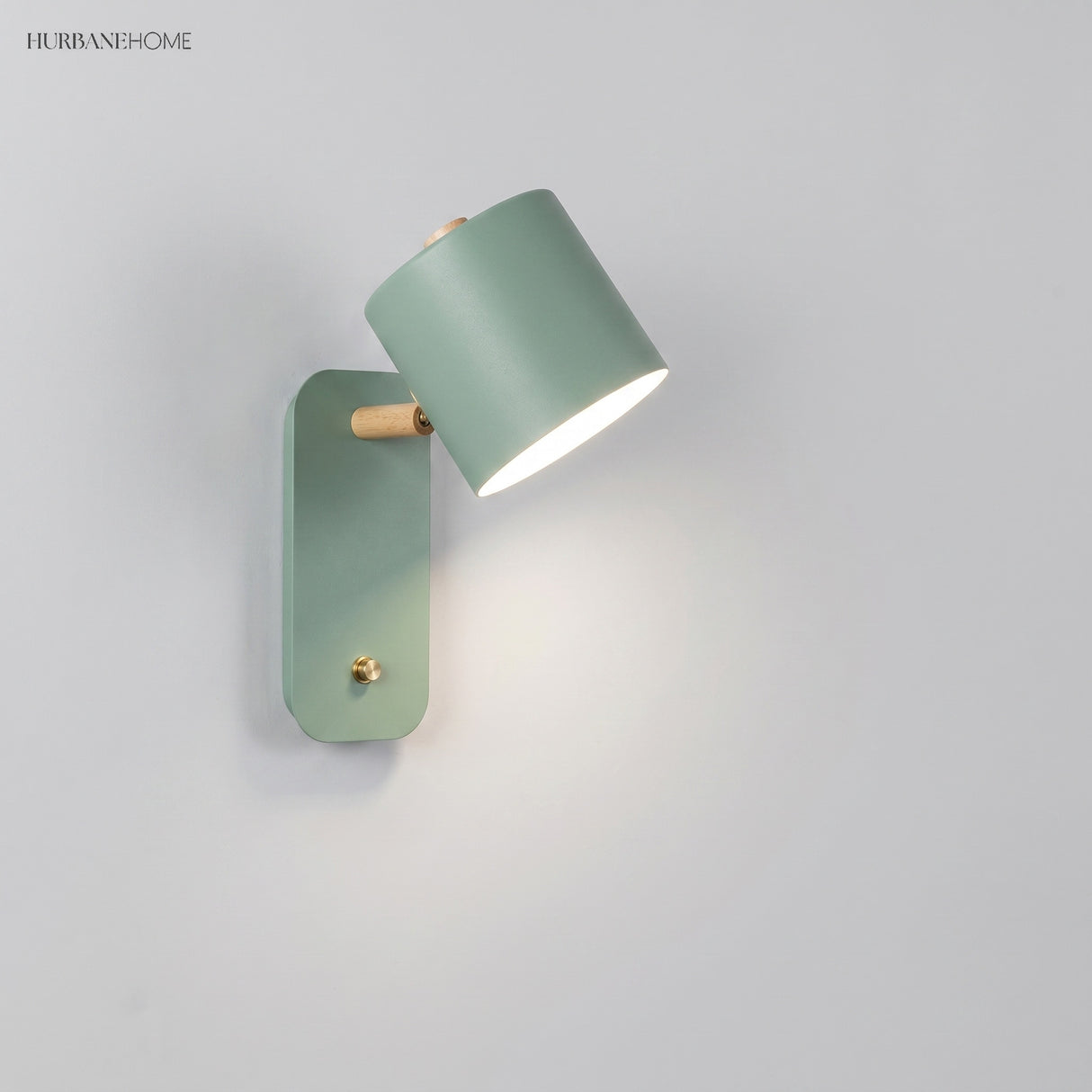 Rotatable cylinder wall sconce in a styled bedroom