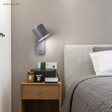 Rotatable cylinder wall sconce in a styled bedroom