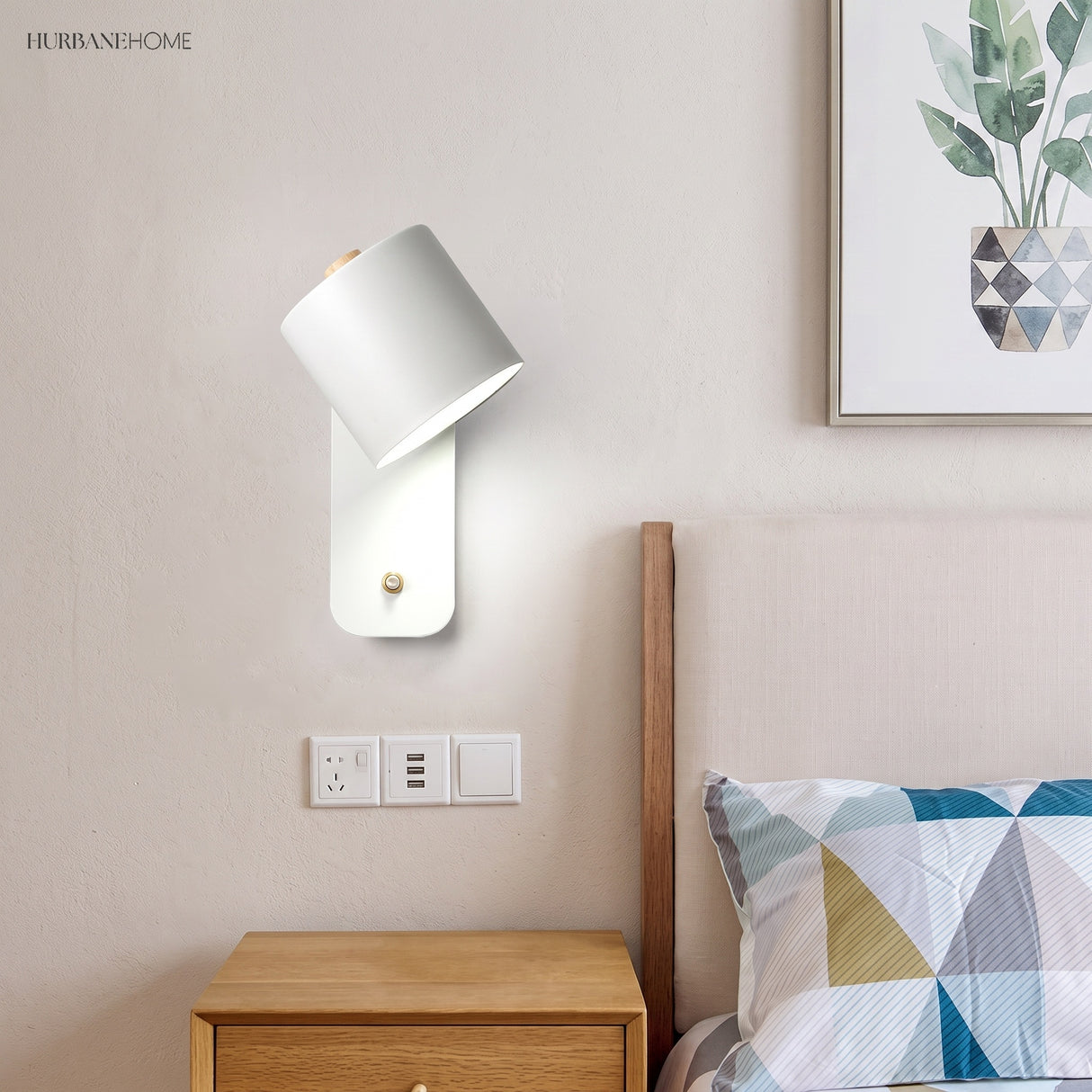 Rotatable cylinder wall sconce in a styled bedroom
