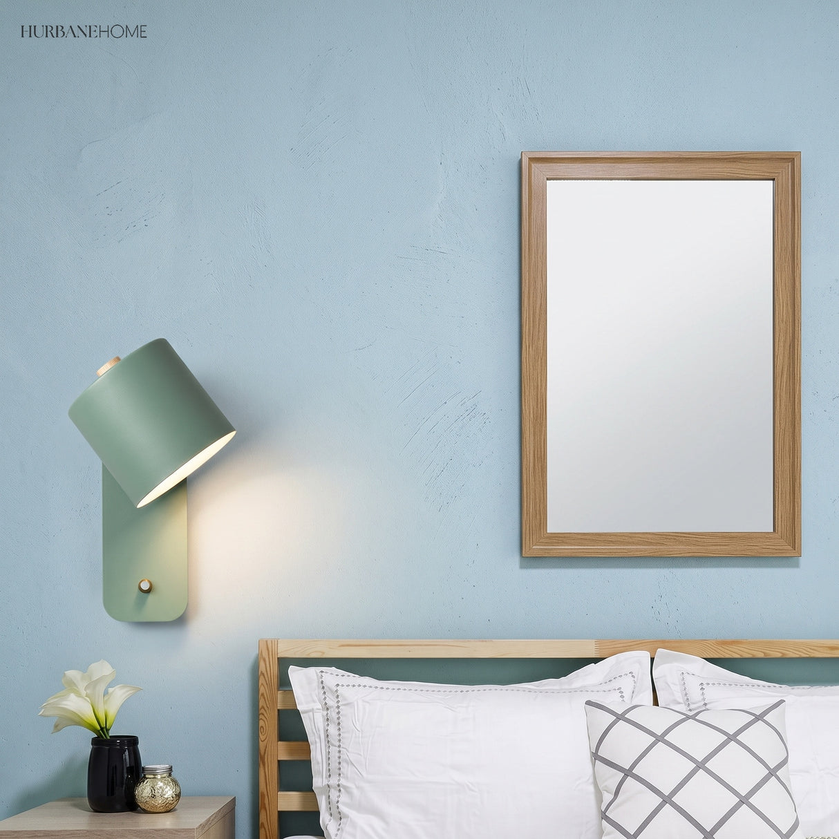 Rotatable cylinder wall sconce in a styled bedroom
