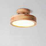 Round wood grain flush mount LED ceiling light shown as a studio product photo