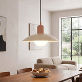 Beige dome pendant light with glowing glass globe over a dining table