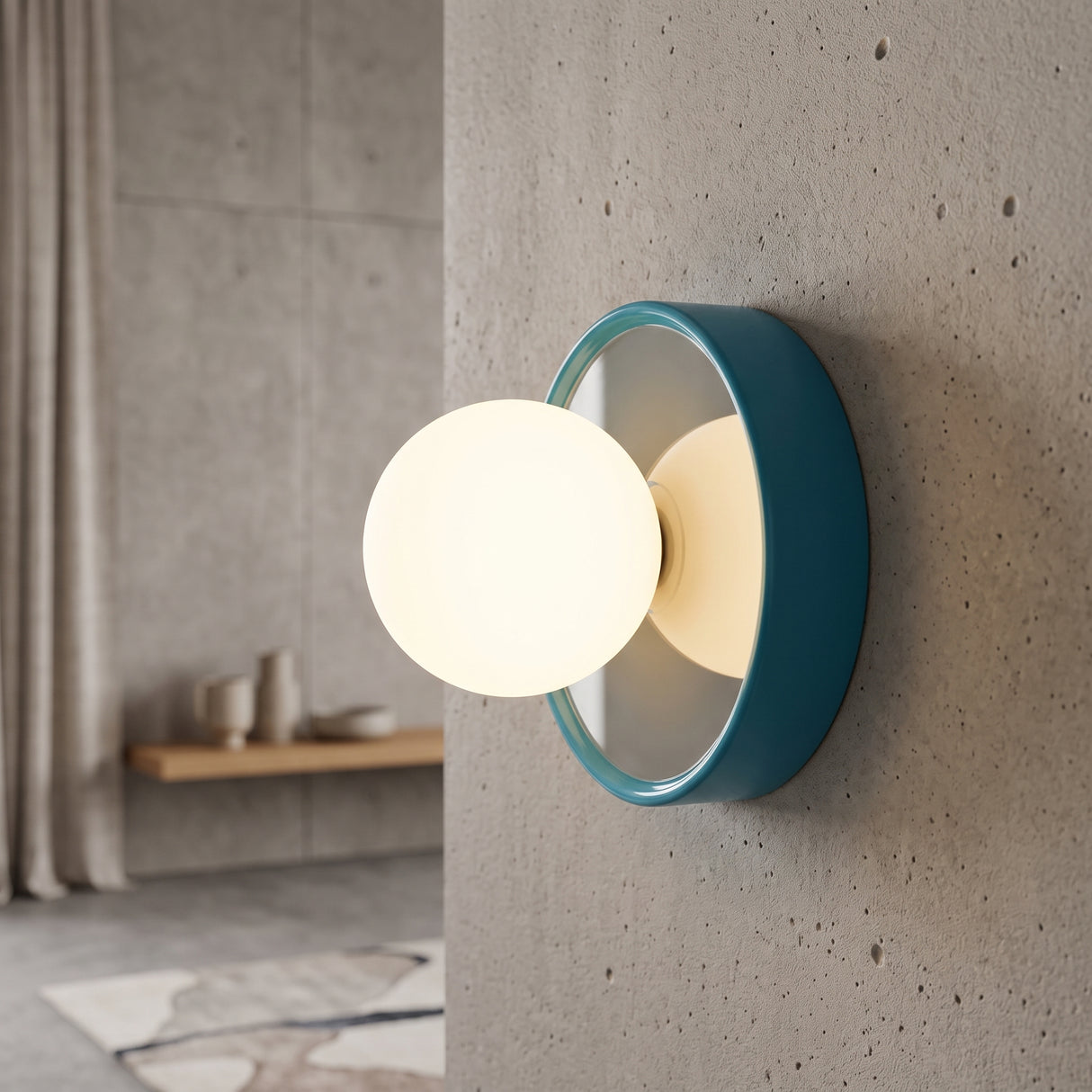 Blue orb wall sconce with a frosted glass globe on a concrete wall