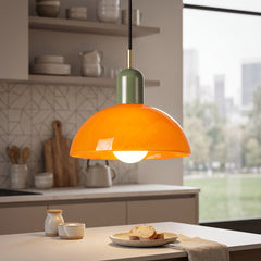 Orange glass bowl pendant light with olive green metal cap and brass neck