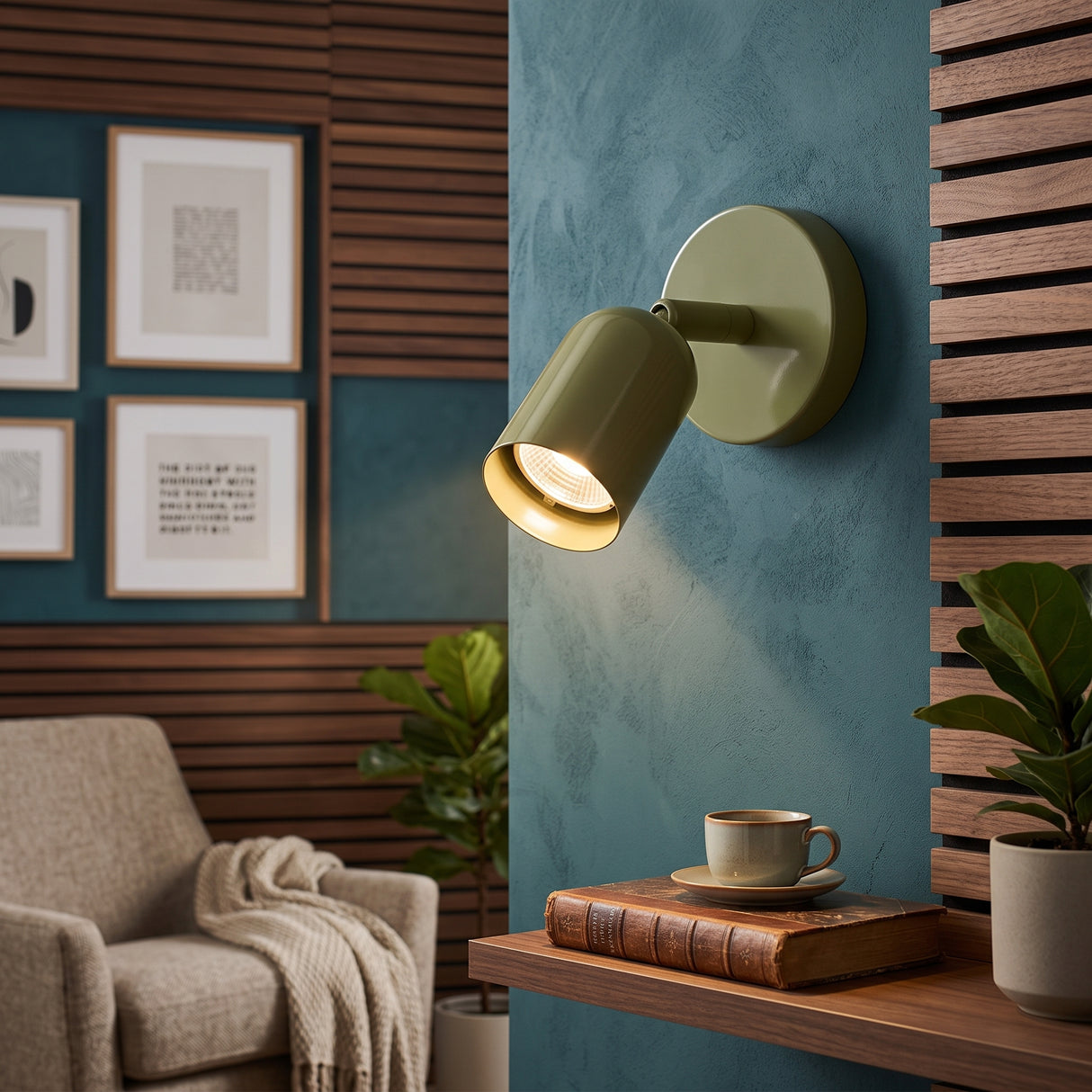 Green adjustable LED wall sconce with rotatable cylindrical shade on blue plaster wall
