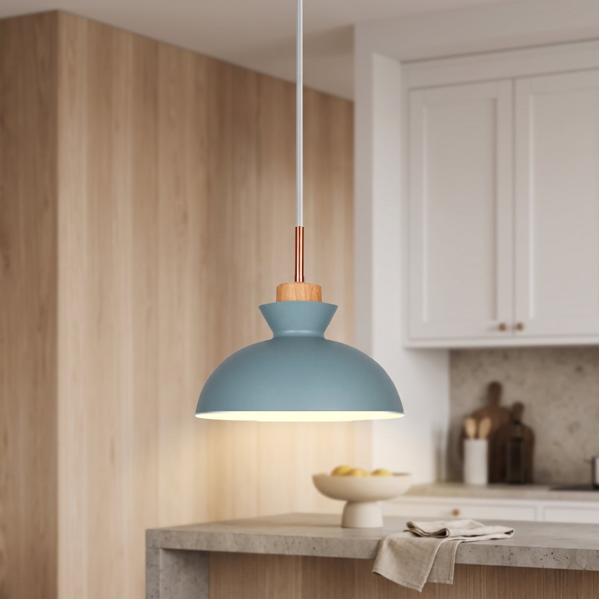 Blue metal dome pendant light with wood accent and copper stem in a modern kitchen