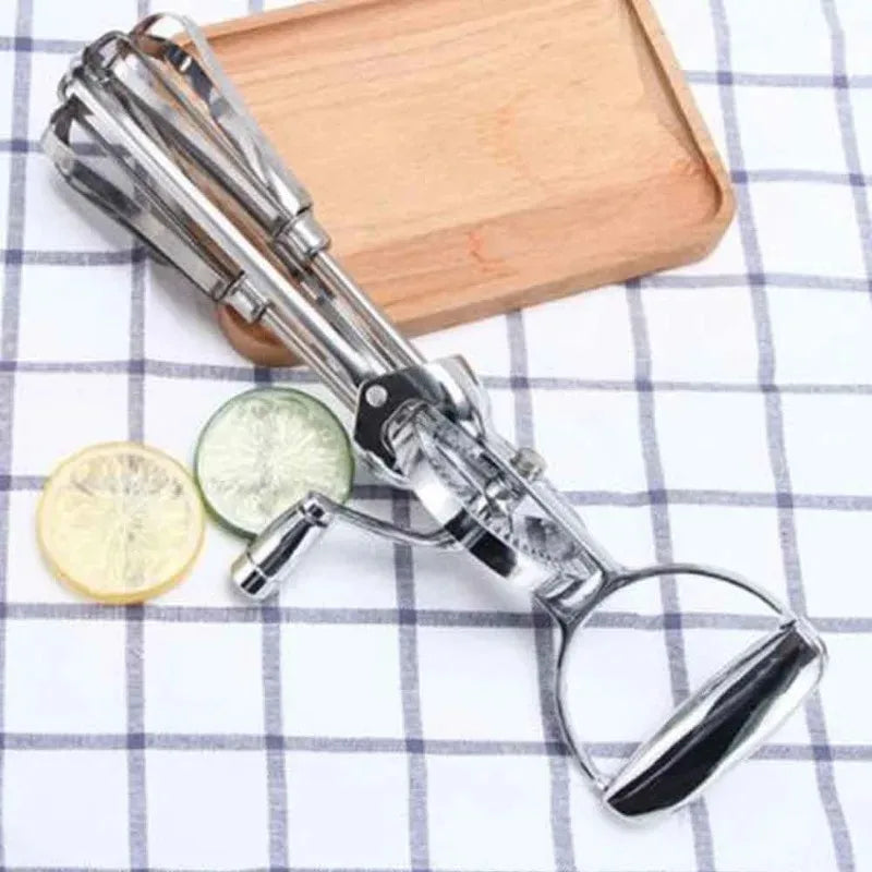 Vintage manual hand mixer on wooden kitchen countertop