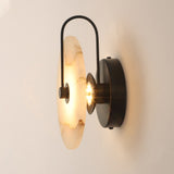 Side view of the marble disc, black arm and round wall plate