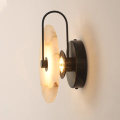 Side view of the marble disc, black arm and round wall plate