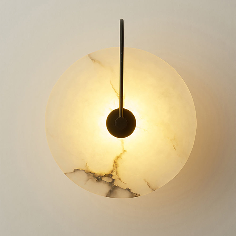 Warm lit marble disc showing the natural veining across the stone