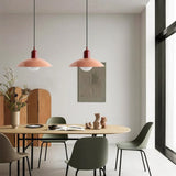 Beige metal disc pendant light with a soft glowing glass globe
